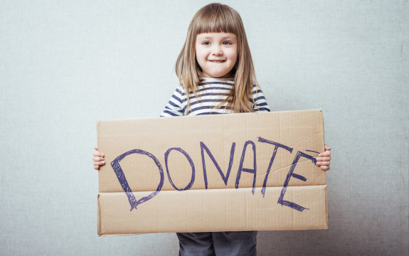 image of a child with a donation box